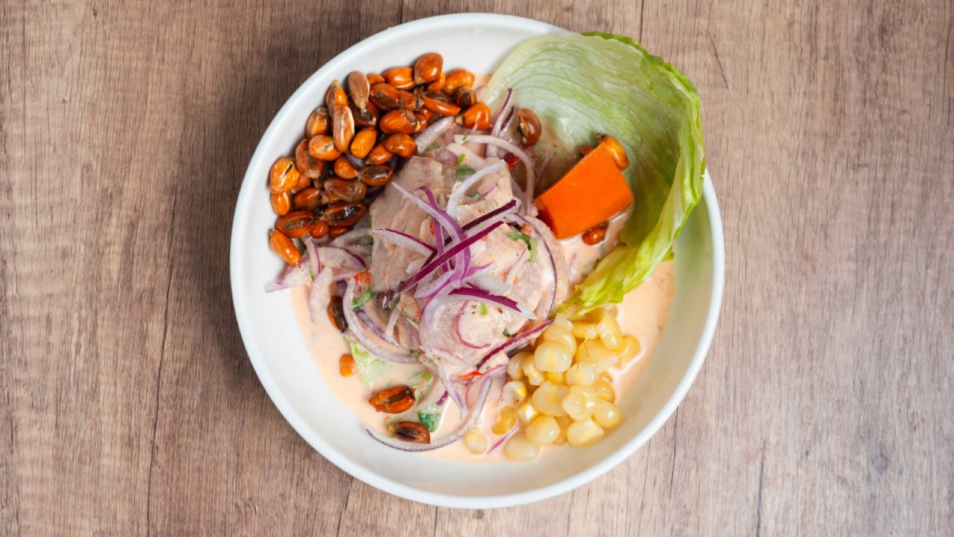 Fresh ceviche de pescado with sweet potato and Peruvian corn
